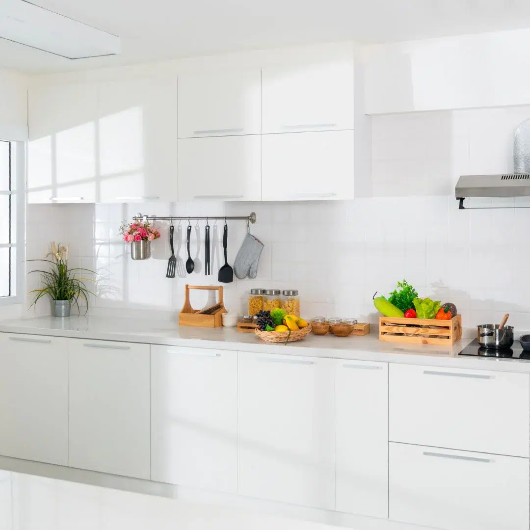 House Cleaning TIps: Eco-friendly cleaning supplies and tools neatly arranged on a countertop, including baking soda, vinegar, microfiber cloths, and a mop bucket.
